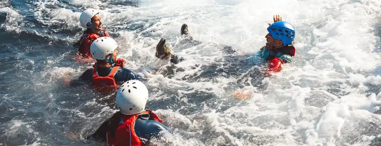 Families and beginners enjoying a safe guided coasteering experience in Ibiza